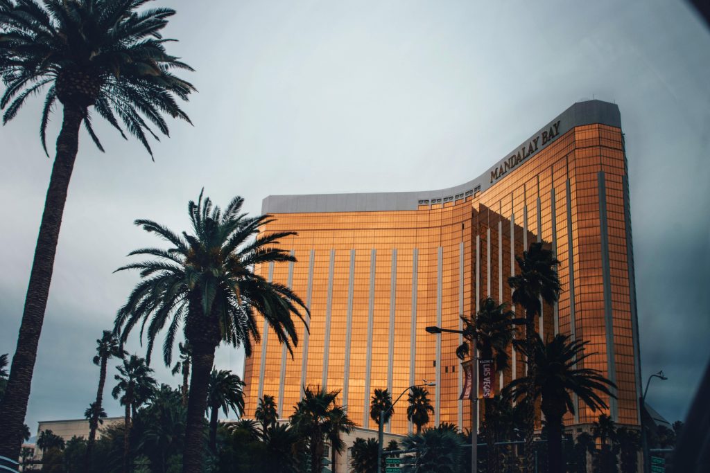 Golden facade of Mandalay Bay Resort amidst palm trees in Las Vegas, Nevada.